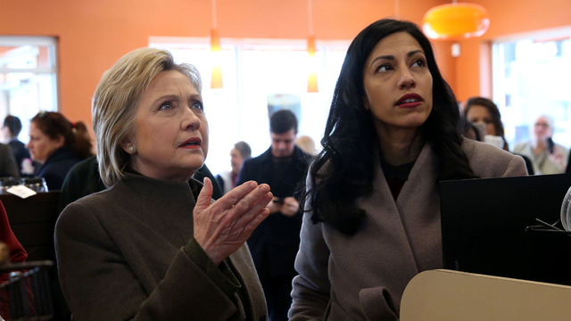 MANCHESTER, NH - FEBRUARY 7: Democratic presidential candidate former Secretary of State Hillary Clinton (C) prepares to order food at a Dunkin Donuts with New Hampshire state campaign director Mike Vlacich (L) and aide Huma Abedin (R) on February 7, 2016 in Manchester, New Hampshire. With less than one week to go before the New Hampshire primaries, Hillary Clinton continues to campaign throughout the state.  (Photo by Justin Sullivan/Getty Images)