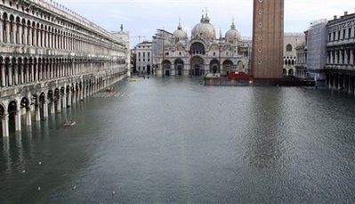 Flooded St. Marks Square, with St. Marks Basilica in the background, in Venice, northern Italy